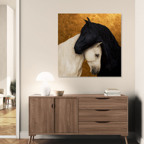 Black and white horse painting on a gold background, adding natural elegance to a contemporary room.