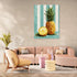 Pineapple wall art on a turquoise striped background in a cozy Scandinavian living room