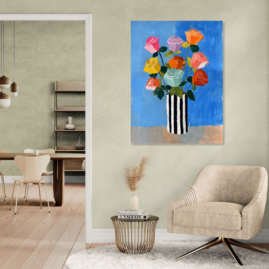 Colorful floral wall art on a vivid blue background with a black-and-white striped vase, modern and chic decor