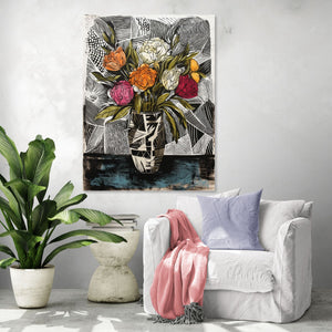 Colorful floral artwork with black-and-white vase, elegant setting in a contemporary living room