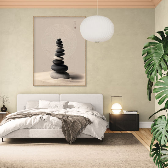 Tableau zen avec pierres empilées sur fond sable, ambiance apaisante dans une chambre moderne
