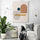 a Scandinavian geometric canvas art hangs in a sleek white minimalist living room
