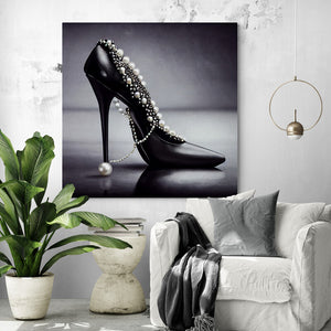 Large stiletto canvas with rhinestones in a living room, in black and white, highlighting a close-up of a stiletto. Elegant and chic, adorned with rhinestones and pearls, this stiletto instantly evokes femininity and ambition. In this canvas, the shoe is elevated, presented in an elegant and confident manner, exuding a sense of power.
