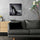 Small black and white stiletto shoe wall art in living room – close-up of elegant high heel with rhinestones and pearls, exuding strength and style