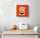 Small kitchen wall art featuring a Japanese Lucky Cat (Maneki Neko) on a white wall; below are a dining table and two white chairs, with a melon and a bread box on the table