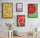 Neutral beige and gray room gallery wall with black-framed canvases featuring colorful fruit slice kitchen decor